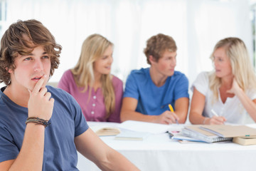 Close up of a thinking man sitting in front of his friends