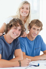 Three smiling students as they look at the camera