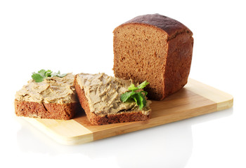 Fresh pate on bread on wooden board isolated on white