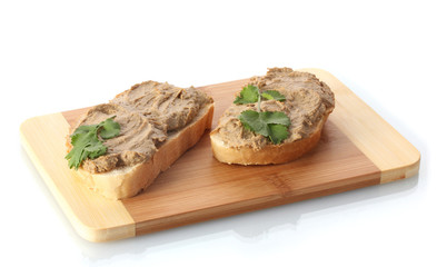 Fresh pate on bread on wooden board isolated on white