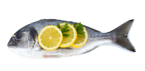 Fresh fish with lemon and parsley isolated on white.