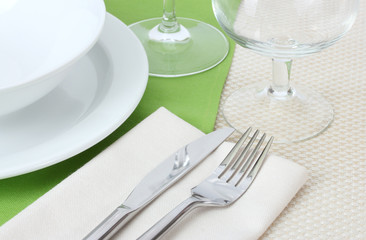 Table setting with fork, knife, plates, and napkin