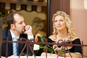 Man and girl with wine at cafe on a date