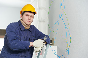 Electrician at cable wiring work