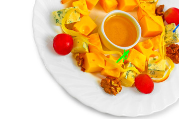 Different types cheese appetizer with honey, nuts and grapes on