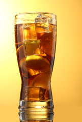 Iced tea with lemon and lime on yelow background