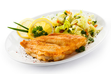 Fish dish - fried fish fillets and vegetable salad