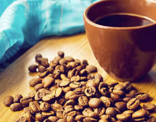 brown cup and coffee beans