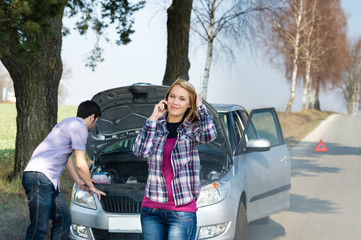 Car breakdown couple calling for road assistance