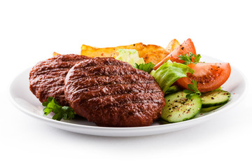 Grilled beefsteaks, baked potatoes and vegetable salad