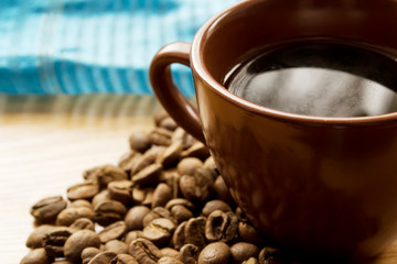 brown cup and coffee beans