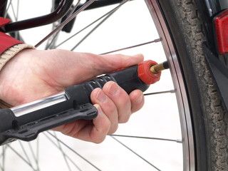 Pumping a tire, closeup, isolated