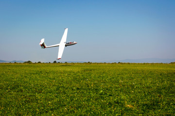 Glider flying on a blue sky