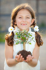 girl holding tree as  nature concept ( focus on child ) - 40854145
