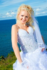 Fototapeta na wymiar beautiful bride on a sea coast