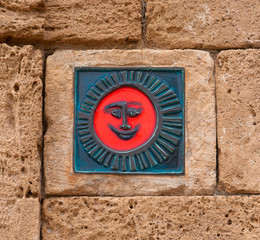 The red symbol on the wall of a smile