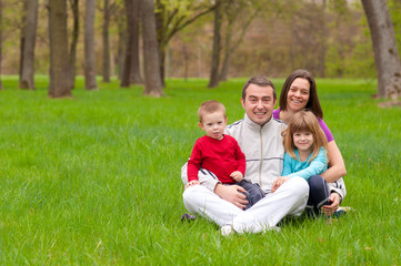 Naklejka na ściany i meble Happy family having fun in the nature on beautiful spring day