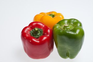 close up of red, yellow and green peppers