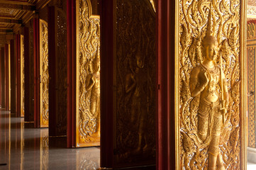 Thai art sculpture on the doors in thai church .