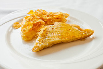 Bread topped with honey on a white dish