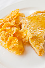 Bread topped with honey on a white dish