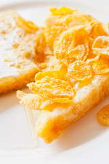 Bread topped with honey on a white dish