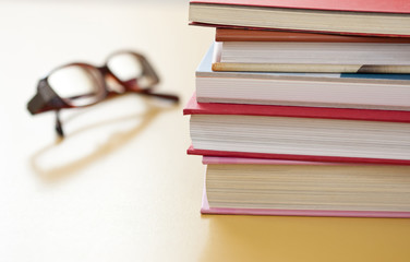 Stack of books and glasses