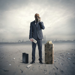 businessman with gasmask at phone