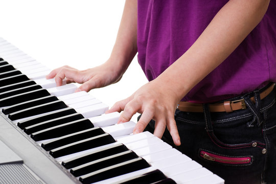 Close Up Of Young Girl  Playing Keyboard