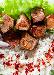 fried meat with rice and vegetables