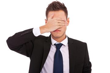 business man making the see no evil gesture