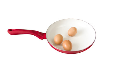 Three chicken eggs in a frying pan