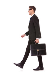 business man holding brief case and walking