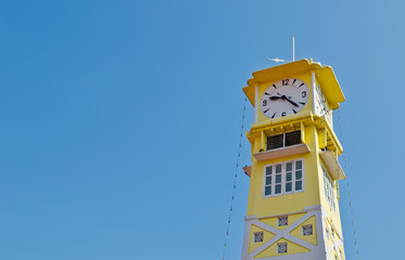 Yellow clock tower with blue sky