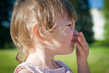 A little girl in a summer park