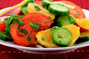 Close-up view of mixed fruits and vegetables salad.