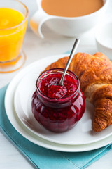 Jar of Raspberry Jam and Croissant on a Plate