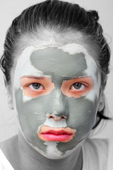 Sad teenager with grey cosmetic mask
