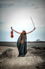 The red-haired girl with a violin outdoor