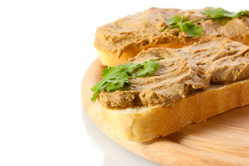Fresh pate on bread on wooden board