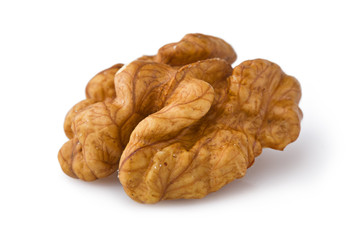 Extreme close-up of walnut seed isolated on white