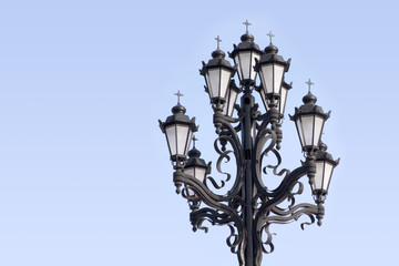 Fototapeta na wymiar Retro styled lighting lantern over blue sky