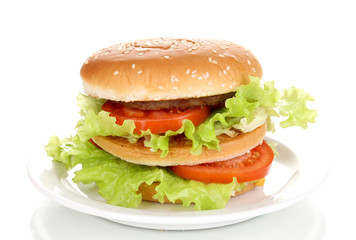 Big and tasty hamburger on plate isolated on white