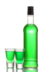 bottle and two glasses of absinthe isolated on white