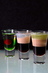 three cocktails layered shots
