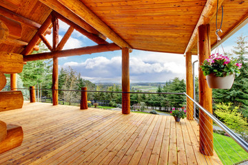 Beautiful view of the log cabin house porch. - obrazy, fototapety, plakaty