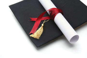 A university diploma with a red ribbon isolated on white