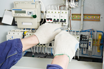 Electrician tighten the screws with spanner