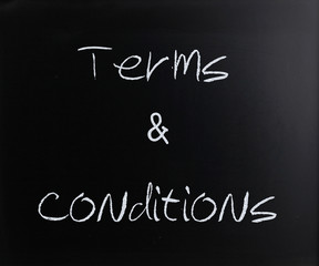 "Terms & Conditions" handwritten with white chalk on a blackboar