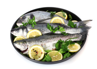 Fresh fishes with lemon, parsley and pepper
